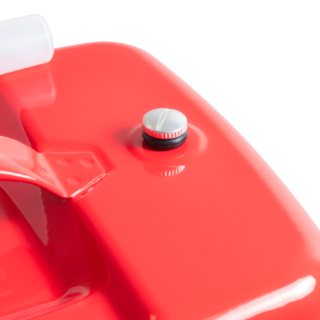 Close-up of a red plastic fuel canister with a silver screw cap visible on the top surface.